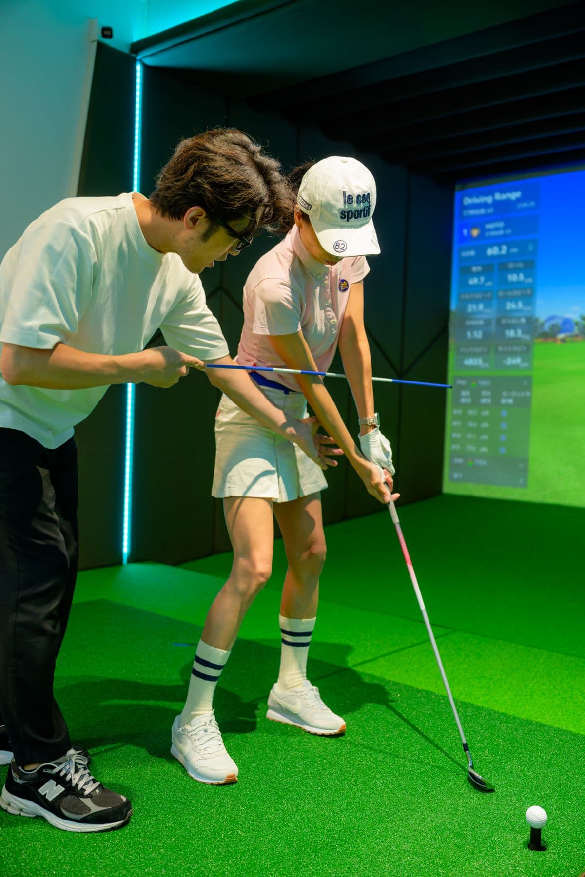 Coach adjusting a student's grip